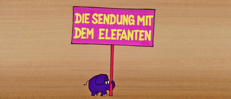 Der Elefant hält ein Schild mit der Aufschrift "Die Sendung mit dem Elefanten"