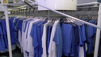 blaue und weiße Sachen hängen auf Kleiderbügeln dicht aneinander
