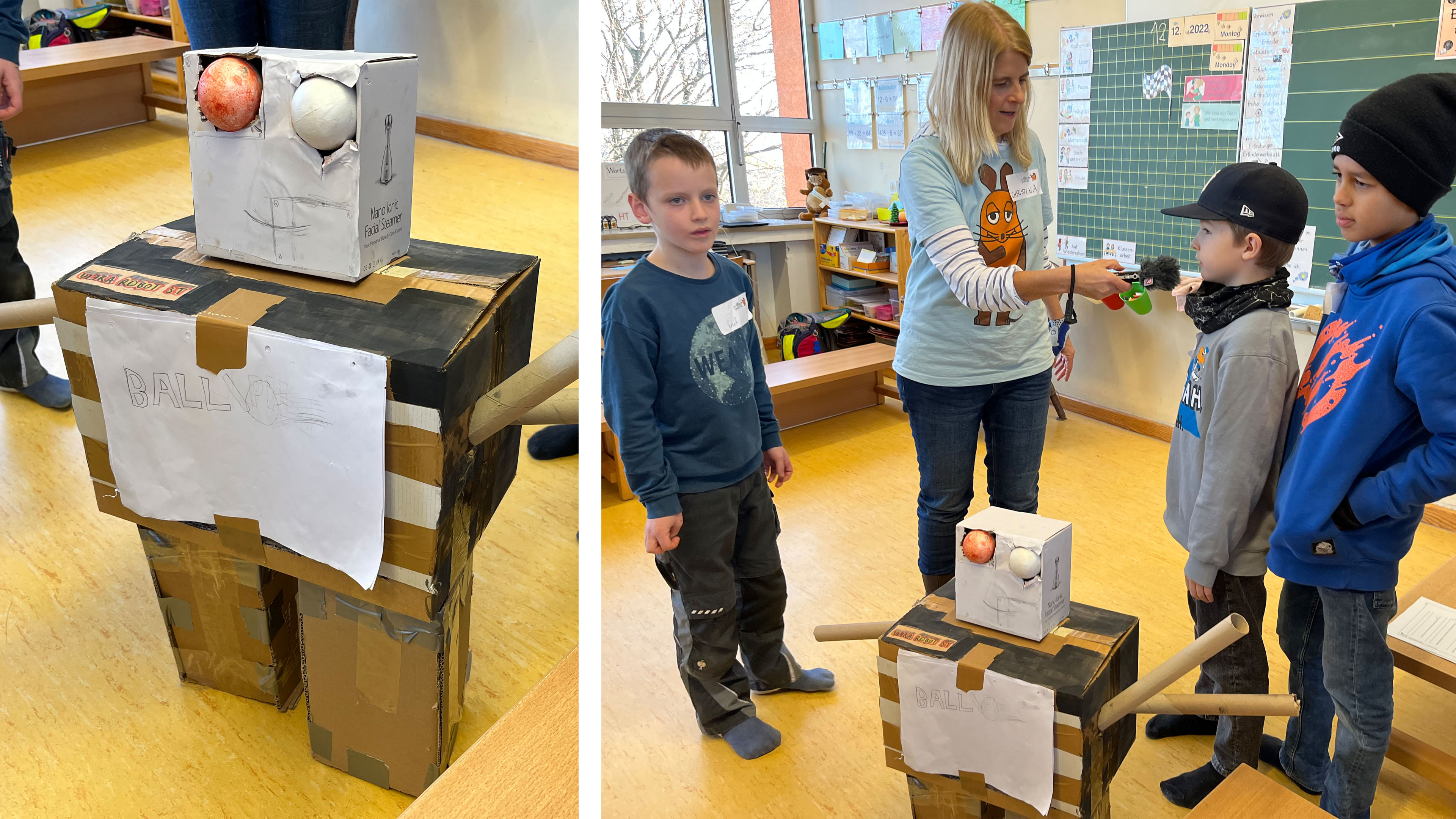 Kinder geben neben ihrem selbst gebauten Papp-Roboter ein Interview