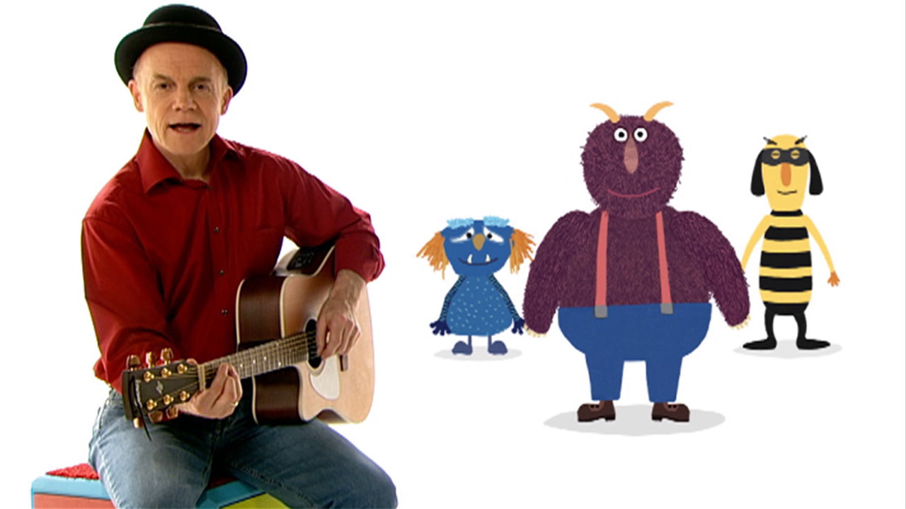 Robert Metcalf singt ein Lied mit Gitarre und den Monster-Figuren (Animation)