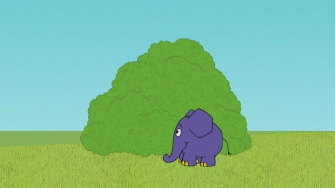 Der Elefant steht vor einem Busch